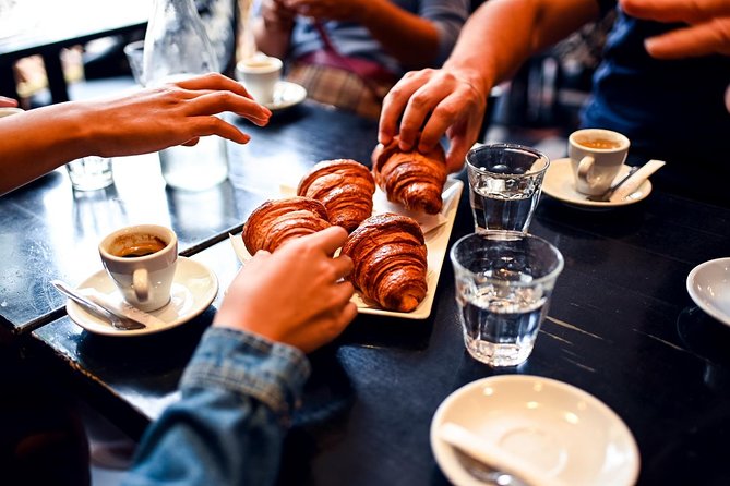 Paris Le Marais Food Tour With 10+ Tastings, Cheese, Wine & More - The start on Rue Saint-Antoine: croissant-and-coffee energy